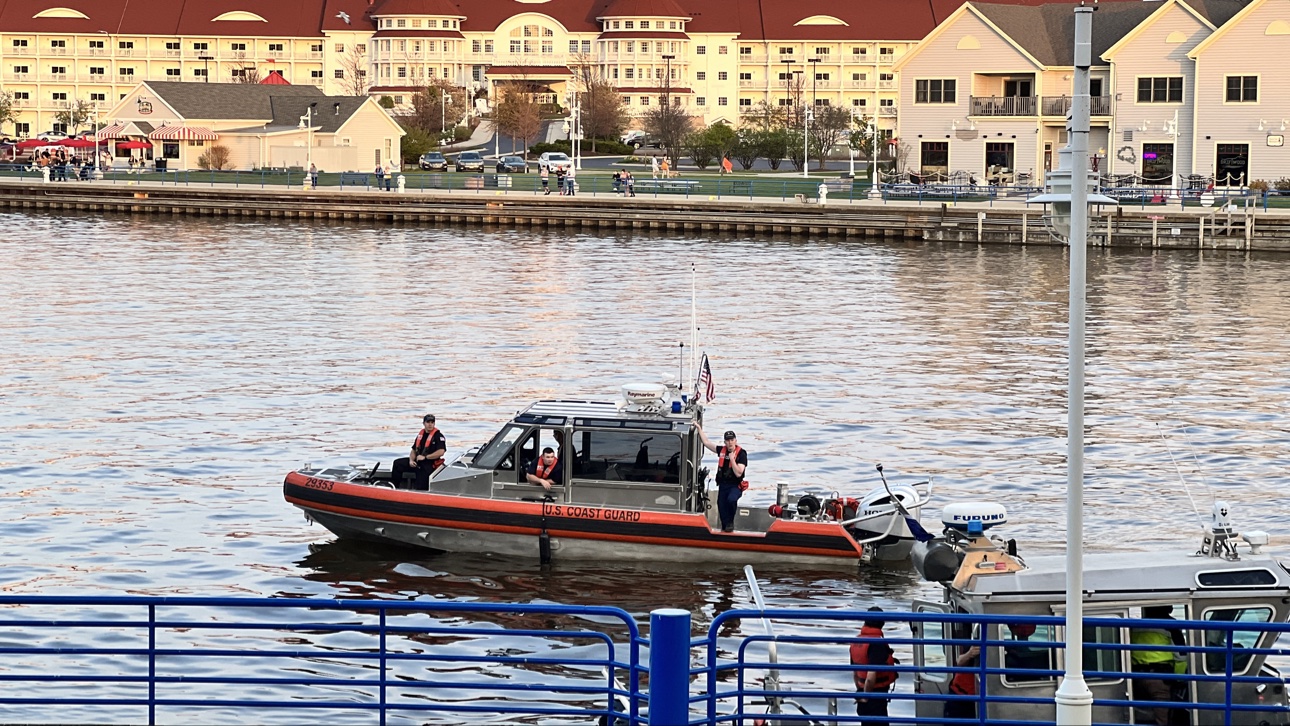 U.S. Coast Guard boat on the river with Blue Harbor Resort behind
