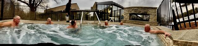 outdoor hot tub, six men, stone fireplace (water/bathing companion