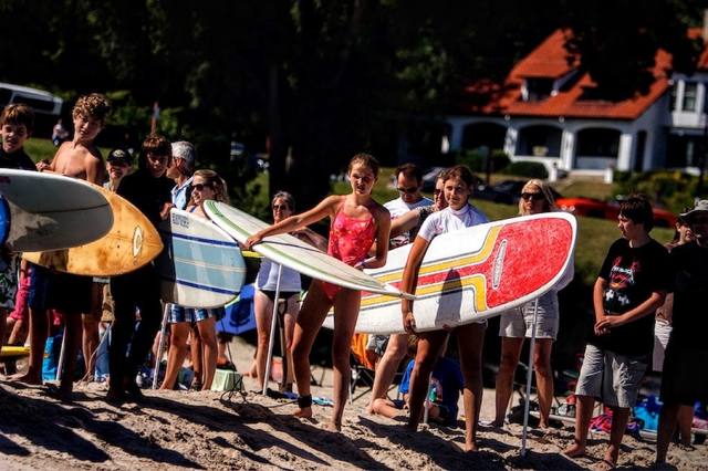 surfer with the flame-painted McTavish board, group with boards behind) — joins the two surfer wave shots and the poster on #57/#58