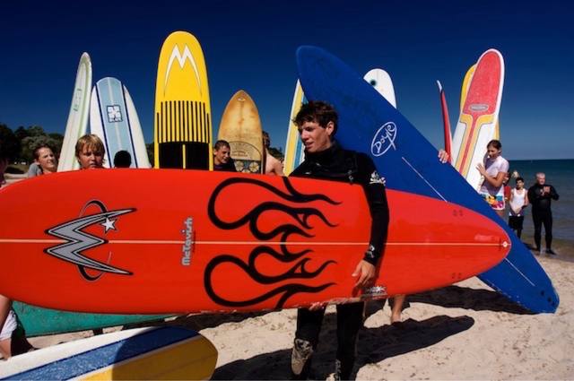 surfer with the flame-painted McTavish board, group with boards behind) — joins the two surfer wave shots and the poster on #57/#58