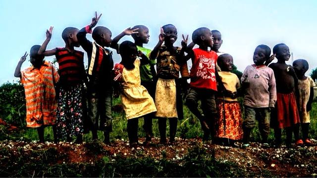 line of African kids flashing peace signs