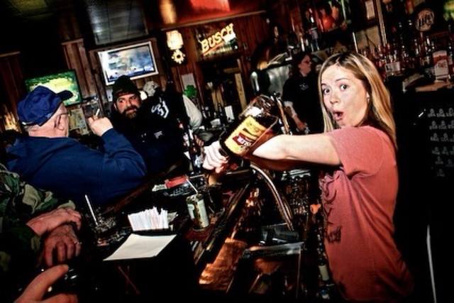 bartender pouring, Busch sign on the wall