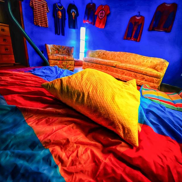 colorful bedroom, shirts hung on the blue wall