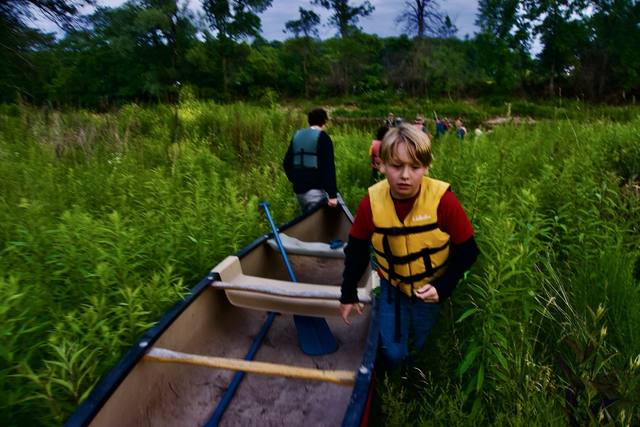 kid in canoe, tall grass) — no exact card