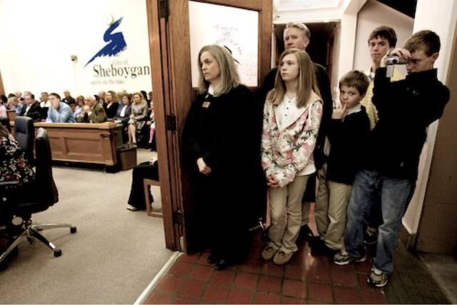 family watching from the chambers doorway ("City of Sheboygan — Spirit on the Lake"