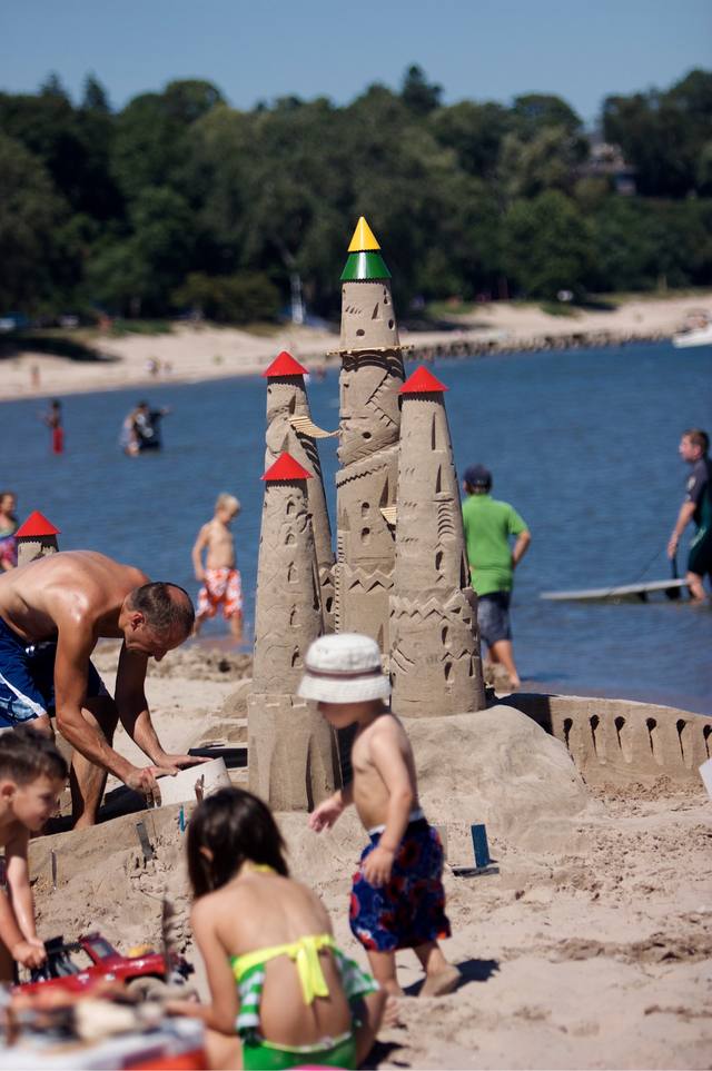 the elaborate Lake Michigan sandcastle, three angles, kids and family building it