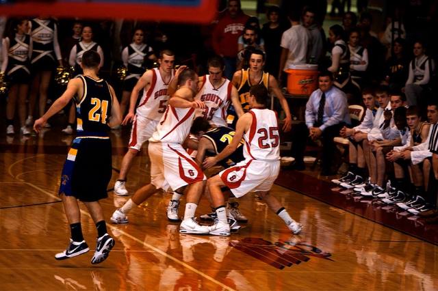loose-ball scramble under the bench (North 21; South 5, 25, 35