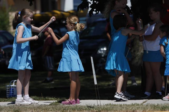 girls in blue dresses with batons
