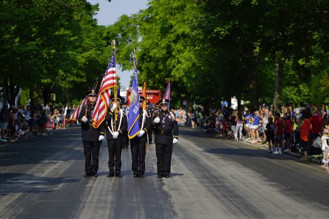 police honor guard with U.S. and Wisconsin colors marching, two angles