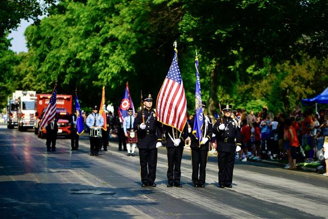 police honor guard with U.S. and Wisconsin colors marching, two angles