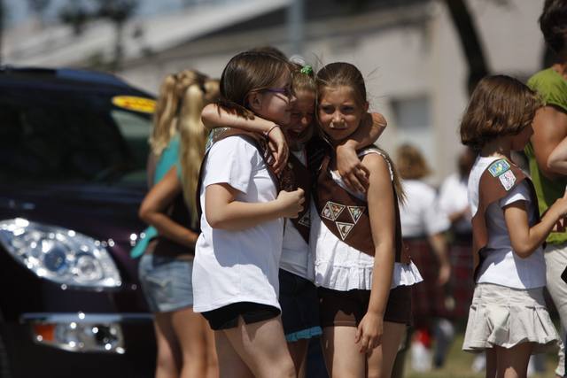 Girl Scouts hugging in the parade line