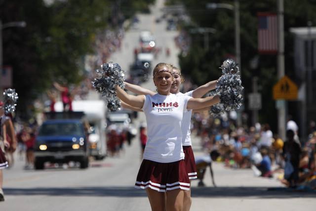 North High School poms marching with silver pom-poms