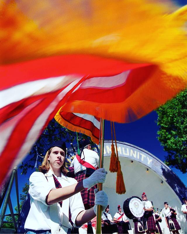 Flag bearer before the bandshell — Clan Donald Pipes & Drums