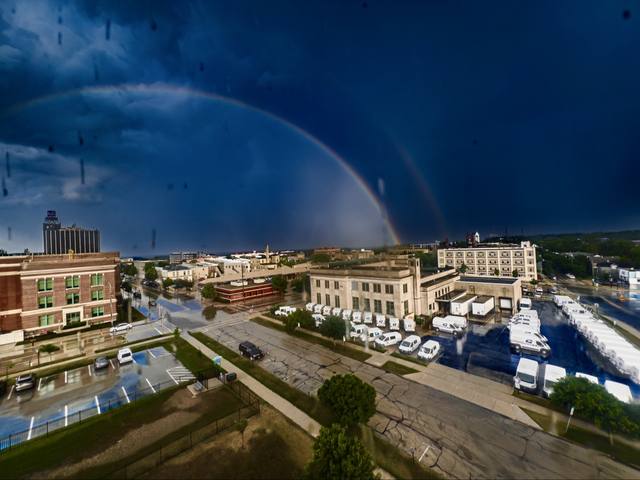 rainbow over downtown Sheboygan, post office and mail trucks