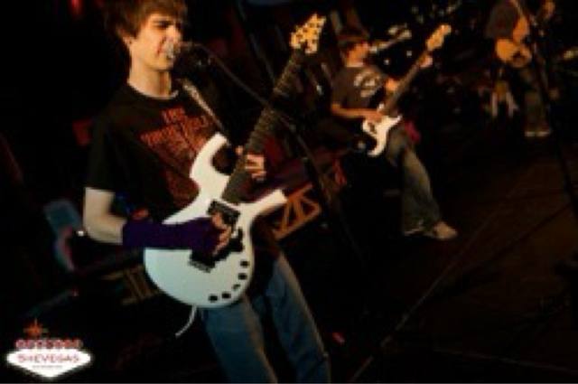 young band on stage, "Welcome to Fabulous SheVegas" mark bottom-left